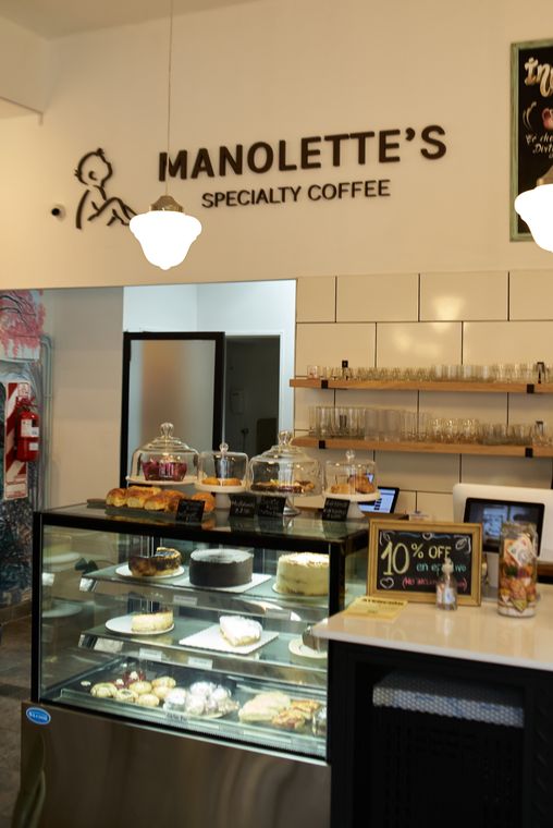 La barra con la vitrina de pastelería y el cartel de Manolette’s